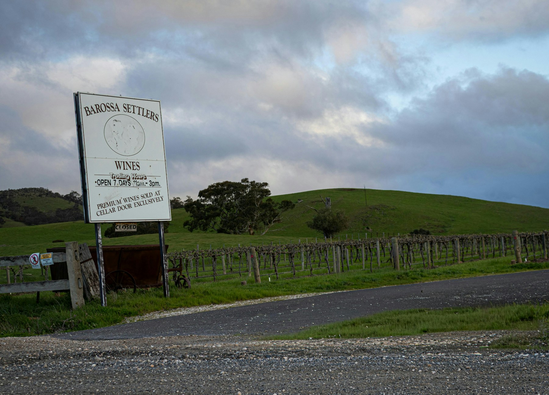 A winery sign at the roadside in the Barossa Valley, with green hills behind